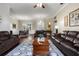 Spacious living room with hardwood floors, neutral paint, comfortable seating, and ceiling fan at 8909 N Campbell Rd, Lakeland, FL 33810