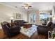 Spacious living room with dark wood floors, a cozy seating arrangement, and ample natural light at 8909 N Campbell Rd, Lakeland, FL 33810
