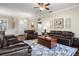 Comfortable living room features dark wood floors, a plush leather sofa, and a decorative area rug at 8909 N Campbell Rd, Lakeland, FL 33810