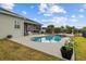 Backyard pool and patio area with lush green grass at 8909 N Campbell Rd, Lakeland, FL 33810