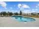 This backyard features a luxurious in-ground pool with a waterfall feature and lounge chairs at 8909 N Campbell Rd, Lakeland, FL 33810