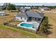 Backyard features a screened-in pool with a hot tub and ample seating area surrounded by a fence at 8909 N Campbell Rd, Lakeland, FL 33810