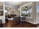 Bright dining area with dark wood floors and views into the sunroom and living room at 8909 N Campbell Rd, Lakeland, FL 33810