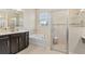 Modern bathroom features a glass shower and soaking tub at 1001 Lena Run Ct, Winter Haven, FL 33880