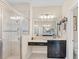 Bathroom features a glass shower and an elegant black vanity at 1001 Lena Run Ct, Winter Haven, FL 33880