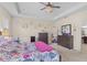 Spacious bedroom boasts modern lighting, floral wall decorations, and beautiful furniture at 1001 Lena Run Ct, Winter Haven, FL 33880