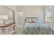Cozy bedroom featuring carpet flooring, a window and an accent table with a lamp at 1001 Lena Run Ct, Winter Haven, FL 33880
