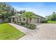 Attractive home featuring a brick driveway, well-maintained lawn, mature landscaping and a side entry garage at 1001 Lena Run Ct, Winter Haven, FL 33880