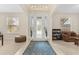 Bright foyer with tile flooring, decorative chandelier, and a glass front door allowing natural light at 1001 Lena Run Ct, Winter Haven, FL 33880