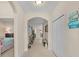 Arched hallway with tile floors and decorative furniture at 1001 Lena Run Ct, Winter Haven, FL 33880
