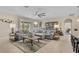 Spacious living room featuring neutral tones, a ceiling fan, and sliding glass doors to the backyard at 1001 Lena Run Ct, Winter Haven, FL 33880