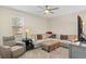 Comfortable living room with plush seating, carpeted floors, and a ceiling fan for added comfort at 1001 Lena Run Ct, Winter Haven, FL 33880