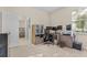 Well-lit office space with neutral tones, a large window, and a view into the bedroom at 1001 Lena Run Ct, Winter Haven, FL 33880