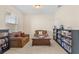 Inviting sitting room with bookshelves, cozy seating, and a large window offering natural light at 1001 Lena Run Ct, Winter Haven, FL 33880