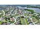 Beautiful aerial view of a well-maintained community featuring ponds and lush greenery near a lake at 1056 Rally Dr, Polk City, FL 33868