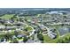 Expansive aerial shot of a serene community featuring well-manicured lawns and a picturesque pond at 1056 Rally Dr, Polk City, FL 33868