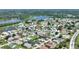 Aerial view of a picturesque neighborhood, highlighting the charming homes and serene lake views at 1056 Rally Dr, Polk City, FL 33868