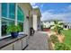Back patio area featuring a grill, outdoor seating, and tropical landscaping for an outdoor oasis at 1056 Rally Dr, Polk City, FL 33868