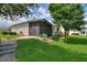 Manicured backyard featuring lush lawn, landscaping, and a screened-in lanai for outdoor enjoyment at 1056 Rally Dr, Polk City, FL 33868