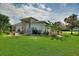 Landscaped backyard with a patio area, generator, and lush greenery for a serene outdoor setting at 1056 Rally Dr, Polk City, FL 33868
