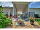 Covered backyard patio with a brick firepit and outdoor seating, perfect for relaxing or entertaining at 1056 Rally Dr, Polk City, FL 33868