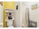 Efficient bathroom with a toilet, shelving, shower, and tasteful decorations for added comfort at 1056 Rally Dr, Polk City, FL 33868