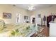 Spacious bedroom featuring wood floors, decorative rug, white furniture and multiple entrances at 1056 Rally Dr, Polk City, FL 33868