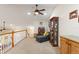 Comfortable bonus room featuring a chaise lounge, wooden display cabinet, and bright overhead lighting at 1056 Rally Dr, Polk City, FL 33868