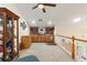 Spacious bonus room with built-in wooden shelving, plush carpeting, and bright, recessed lighting at 1056 Rally Dr, Polk City, FL 33868