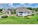 Inviting home with manicured lawn, shrubbery, and an attached porte cochere for convenient parking at 1056 Rally Dr, Polk City, FL 33868