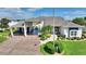 Charming home with a well-manicured lawn, a covered driveway, and inviting curb appeal at 1056 Rally Dr, Polk City, FL 33868