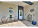 Inviting front porch with decorative touches, seating, and a beautifully adorned entrance at 1056 Rally Dr, Polk City, FL 33868
