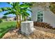 Home generator surrounded by tropical landscaping and providing reliable backup power at 1056 Rally Dr, Polk City, FL 33868