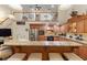 Spacious kitchen features custom wood cabinetry, a granite breakfast bar, and stainless steel appliances at 1056 Rally Dr, Polk City, FL 33868