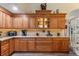 Kitchen featuring custom wood cabinetry, granite counters, under cabinet lighting, and tiled backsplash at 1056 Rally Dr, Polk City, FL 33868