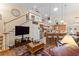 Comfortable living area with vaulted ceilings, staircase to loft, and open access to the kitchen at 1056 Rally Dr, Polk City, FL 33868