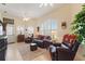 Bright living room with tile floors, a ceiling fan, and large windows for ample natural light at 1056 Rally Dr, Polk City, FL 33868