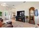 Comfortable living room featuring a fireplace, grandfather clock, and views into the dining area at 1056 Rally Dr, Polk City, FL 33868