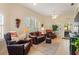 Inviting living room featuring high ceilings, large windows, and comfortable leather furniture at 1056 Rally Dr, Polk City, FL 33868