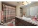 Bathroom with decorative shower curtain, white sink, and dark wood vanity at 1105 Watersedge Dr, Lakeland, FL 33801