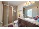 Well-lit bathroom featuring a glass-enclosed shower and dark wood vanity at 1105 Watersedge Dr, Lakeland, FL 33801