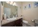 Charming bathroom with a stylish vanity, decorative mirror, and nautical-themed artwork at 1105 Watersedge Dr, Lakeland, FL 33801