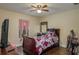 Cozy bedroom with a ceiling fan, hardwood floors, and a bright window at 1105 Watersedge Dr, Lakeland, FL 33801