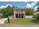 Inviting two-story home featuring a well-manicured lawn, cozy porch, and classic architectural design at 1105 Watersedge Dr, Lakeland, FL 33801