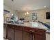 Open-concept kitchen with a breakfast bar, stainless steel sink, and view of the dining area at 1105 Watersedge Dr, Lakeland, FL 33801
