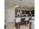 Well-equipped kitchen featuring stainless steel appliances, dark cabinetry, and a convenient breakfast bar at 1105 Watersedge Dr, Lakeland, FL 33801