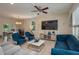 Spacious living room with comfortable seating, a ceiling fan, and a large television for entertainment at 1105 Watersedge Dr, Lakeland, FL 33801