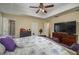 Spacious main bedroom featuring a tray ceiling, ceiling fan, and plenty of closet space at 1105 Watersedge Dr, Lakeland, FL 33801