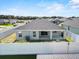 Aerial shot of a fenced backyard with a covered patio and well-kept greenery at 1106 Tropea Ln, Auburndale, FL 33823