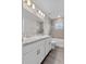 Bathroom features a double vanity with modern faucets, tiled shower, and ample cabinet space at 1106 Tropea Ln, Auburndale, FL 33823